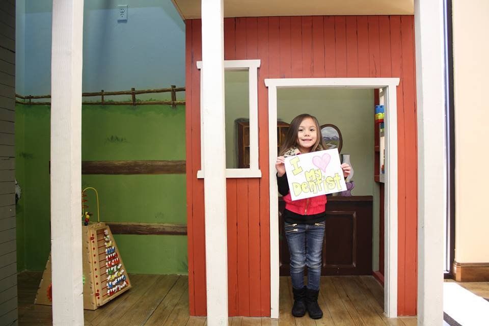 Child smiling during a dental visit at Children's Dental